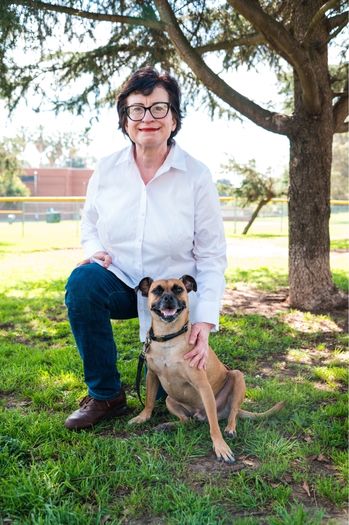 Christina Persandi and a brown dog.